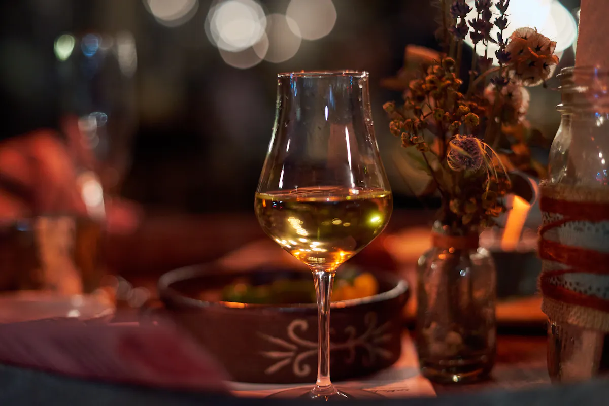 a glass of white wine on a table